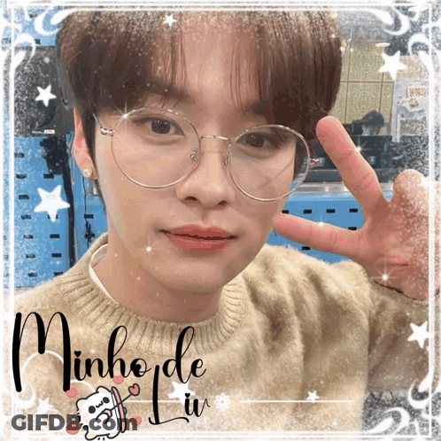 A Picture Of A Young Man With Glasses And The Name Minho GIF