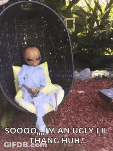 A Picture Of An Alien Sitting In A Chair With The Caption Soooo Im An Ugly Lil Thang Huh ? GIF