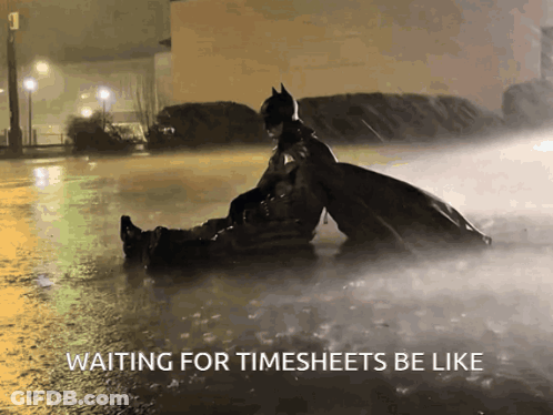 A Picture Of Batman And Robin In The Rain With A Caption That Says Waiting For Timesheets Be Like GIF