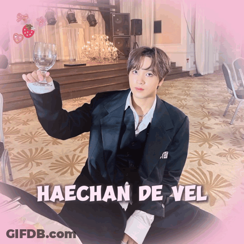 A Picture Of Haechan De Vel With A Glass Of Wine In His Hand GIF