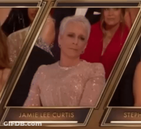 A Picture Of Jamie Lee Curtis Sitting In A Row With Other People GIF