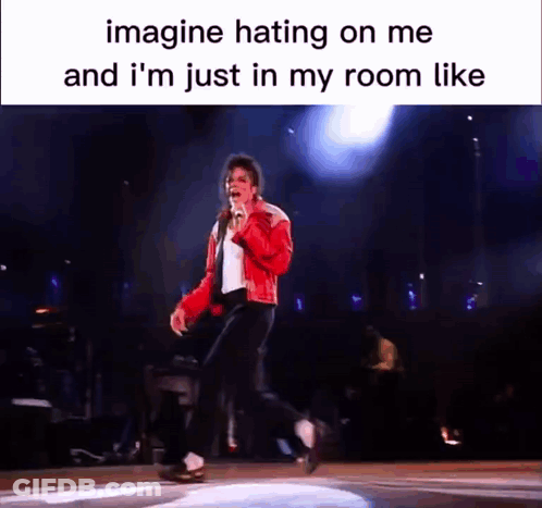 A Picture Of Michael Jackson Singing Into A Microphone On A Stage . GIF