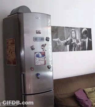 A Picture Of Pulp Fiction Hangs On A Wall Above A Fridge GIF