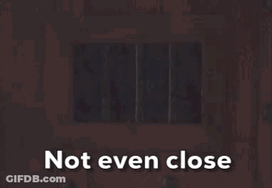 A Picture Of Santa Claus Behind Bars With The Words Not Even Close Above Him GIF