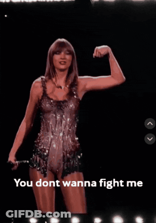 A Picture Of Taylor Swift Flexing Her Muscles With The Words You Dont Wanna Fight Me Below Her GIF