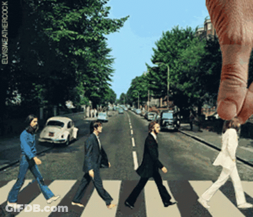 A Picture Of The Beatles Walking Across A Crosswalk With A Hand Reaching Out Towards Them GIF