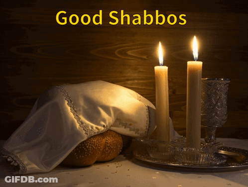 A Picture Of Two Lit Candles And A Loaf Of Bread With The Caption Good Shabbos GIF