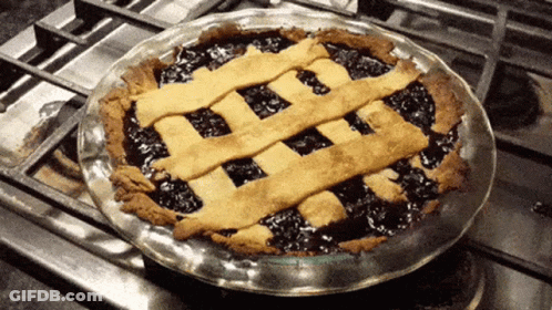 A Pie With A Lattice Crust Is On A Stove GIF