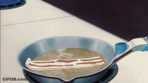 A Piece Of Bacon Is Being Cooked In A Pan GIF