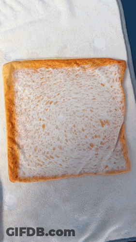 A Piece Of Bread With A White Crust On A White Towel GIF