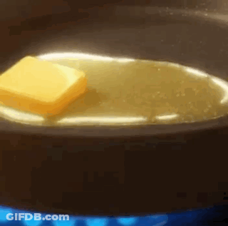 A Piece Of Butter Is Being Melted In A Pan Of Oil . GIF