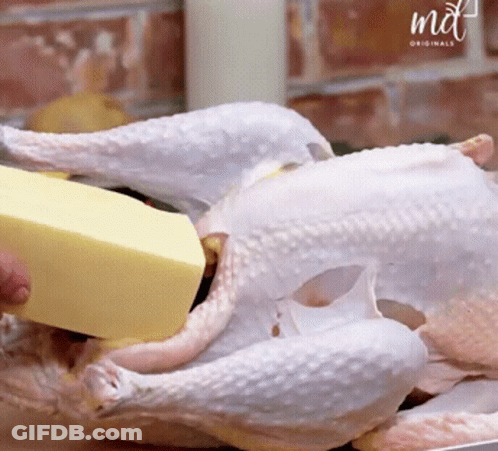 A Piece Of Butter Is Being Poured On A Chicken By A Md Originals Logo GIF