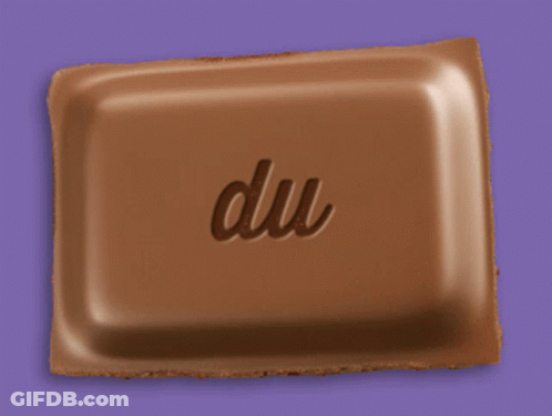 A Piece Of Chocolate With The Word Du Written On It GIF