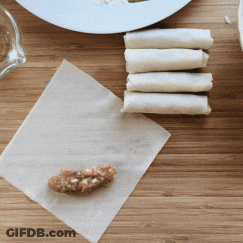 A Piece Of Meat Is Being Wrapped In A Napkin GIF