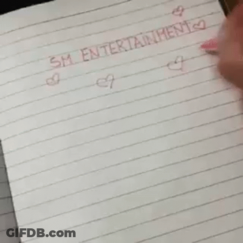 A Piece Of Paper With A Smiley Face On It Is On A Table . GIF