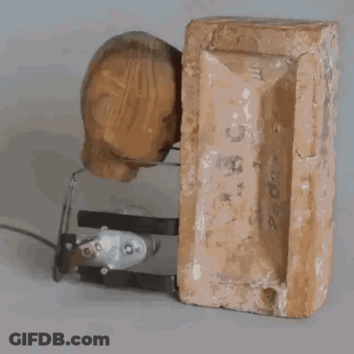 A Piece Of Wood Is Sitting On Top Of A Brick With The Number 2 On It GIF