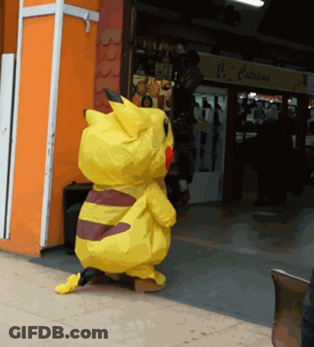 A Pikachu Costume Is Standing In Front Of A Store That Says Catalina GIF