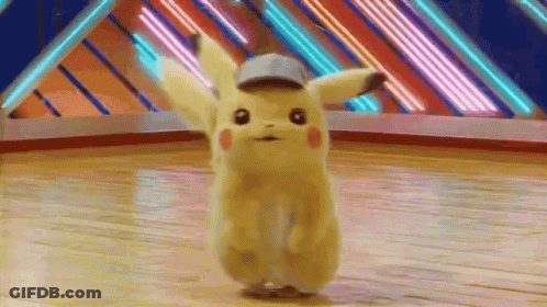 A Pikachu Is Dancing On A Wooden Floor In A Room . GIF