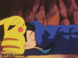 A Pikachu Is Standing Next To A Person Sleeping In A Blue Blanket GIF