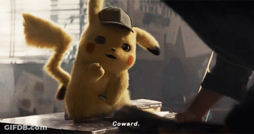 A Pikachu Wearing A Hat Says Coward While Standing On A Table GIF