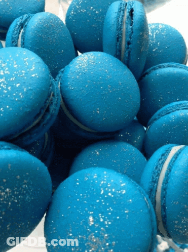 A Pile Of Blue Macarons With Silver Sprinkles GIF