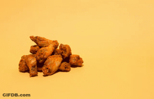 A Pile Of Chicken Wings Next To A Pile Of Chicken Bones On A Yellow Background GIF