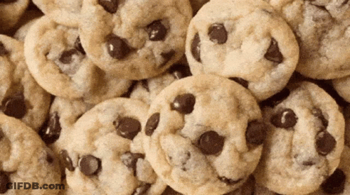 A Pile Of Chocolate Chip Cookies Looks Like A Pile Of Faces GIF