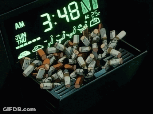 A Pile Of Cigarettes Sits In Front Of A Digital Clock That Says 3:48 GIF