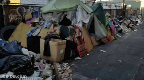 A Pile Of Garbage Including A Sign That Says Laundry Room GIF