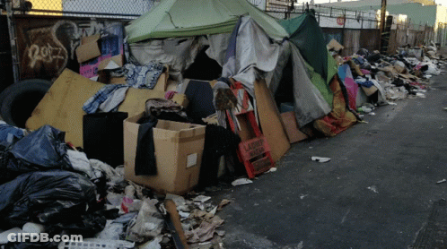 A Pile Of Garbage Including A Sign That Says Laundry Shop GIF