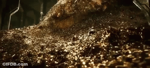 A Pile Of Gold Coins Is Sitting On Top Of A Pile Of Dirt And Rocks . GIF
