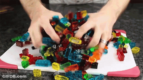 A Pile Of Gummy Bears On A Cutting Board GIF