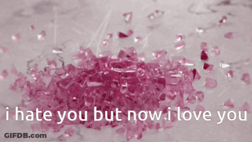 A Pile Of Pink Crystals With The Words " I Hate You But Now I Love You " Below Them GIF