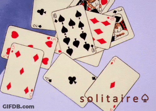 A Pile Of Playing Cards And An Envelope With The Word Solitaire On The Bottom GIF
