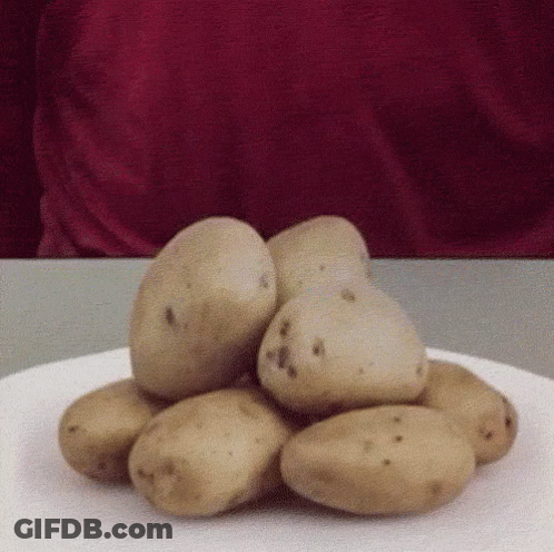 A Pile Of Potatoes Is On A White Plate GIF