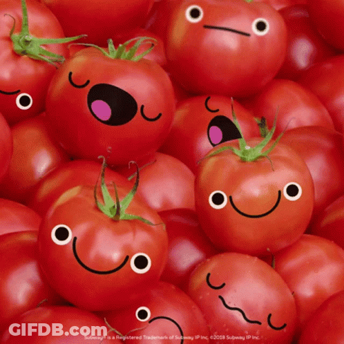 A Pile Of Tomatoes With Smiley Faces On Them GIF