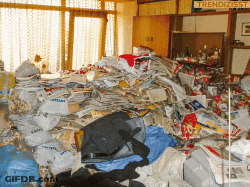 A Pile Of Trash In A Room With A Sign That Says Trendizisst On It GIF