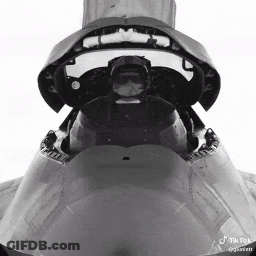 A Pilot Is Sitting In The Cockpit Of A Fighter Jet GIF