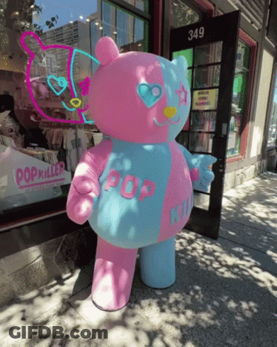 A Pink And Blue Teddy Bear With Pop Written On It GIF