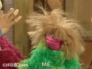 A Pink And Green Puppet With A Messy Haircut Is Standing Next To A Green Puppet . GIF