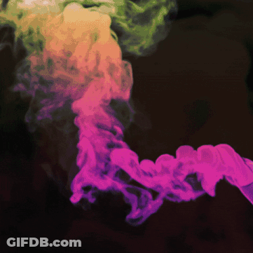 A Pink And Green Smoke Coming Out Of A Black Background GIF