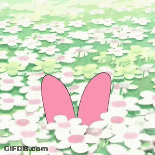 A Pink And White Bunny With A Flower On Its Head Is Jumping In The Air In A Field Of Flowers . GIF