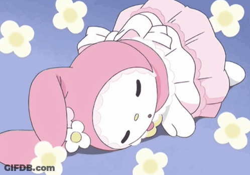 A Pink And White Cartoon Character Is Laying On The Ground With Flowers Around Her GIF