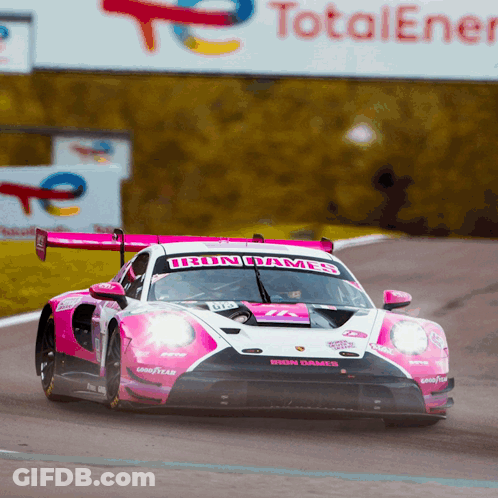 A Pink And White Race Car With The Word Iron On The Front GIF