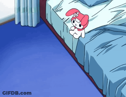 A Pink And White Stuffed Animal Is Sitting On A Bed With Blue Sheets GIF
