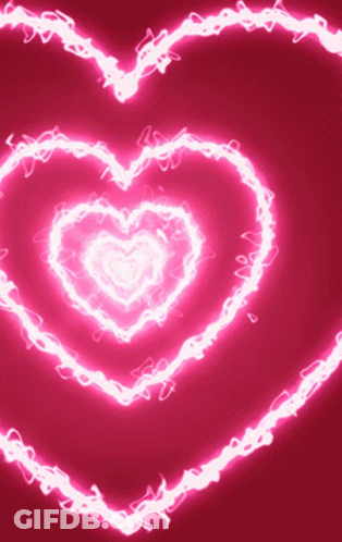 A Pink Background With A Glowing Heart Shaped Pattern GIF