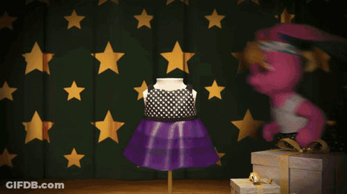 A Pink Bunny Doll Is Standing In Front Of A Green Curtain With Gold Stars GIF