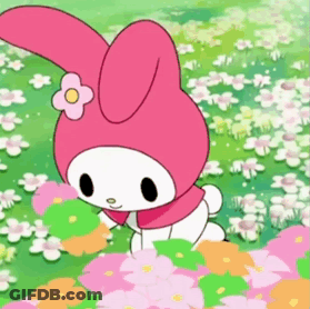 A Pink Bunny With A Flower On Its Head Is Standing In A Field Of Flowers GIF