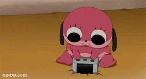 A Pink Cartoon Character Is Sitting On The Ground Holding A Video Game Controller GIF