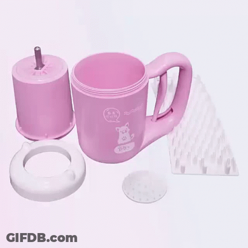 A Pink Mug With A Cat On It Is Being Disassembled On A Table . GIF